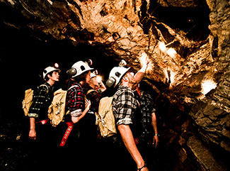 Visitors exploring the rock formations underground at Central Deborah Gold Mine